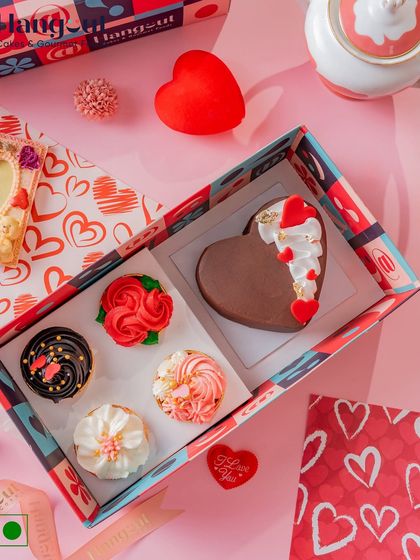 A heart-shaped Dutch truffle bento cake is the star of this Valentine's gift box. It comes with four matching cupcakes, making it a classic and delicious way to say 'I love you'.