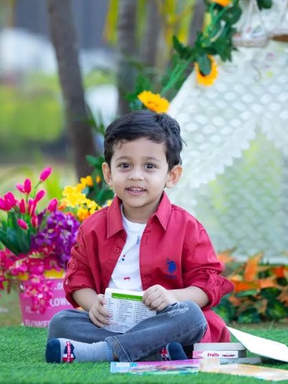 A happy moment from a three-year-old's themed photoshoot. Our tent setups are versatile and can be customized with flowers and props to match your child's favorite colors and interests.