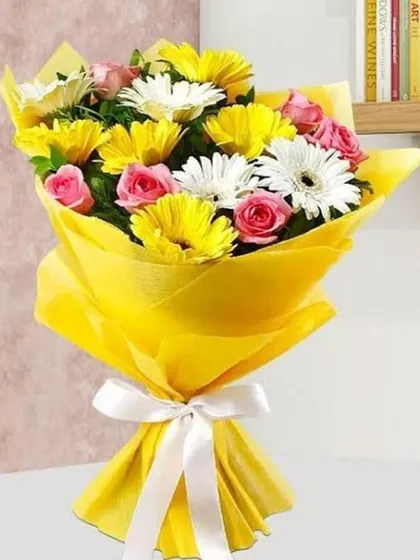 A cheerful bouquet of yellow and white gerbera daisies mixed with pink roses. The bright yellow wrapping makes this a perfect gift to brighten someone's day.