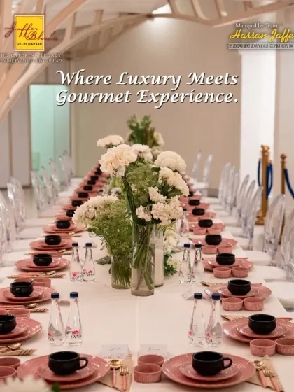 We specialize in creating elegant and luxurious dining experiences. This long table setup, with its pristine white linens, delicate floral centerpieces, and coordinated pink and black dinnerware, shows our attention to every detail for a gourmet sit-down meal.