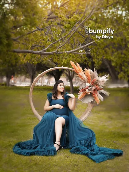 A slightly different angle of the same setup, capturing a joyful, candid expression. The floral arrangement on the prop adds a touch of earthy elegance.