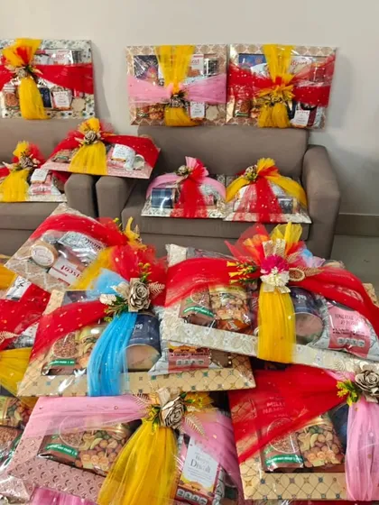 A large order of wedding sagan hampers, wrapped in colorful red, yellow, and blue net, ready to be dispatched.