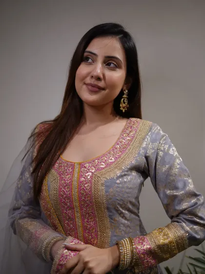 Woven with culture, detailed with beauty. This grey and pink suit set is a work of art.