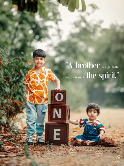 A heartwarming outdoor portrait celebrating the special bond between brothers during a first birthday photoshoot. We always welcome siblings to join in and create lasting family memories.