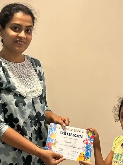 A proud moment as a camper receives her certificate at the end of our first summer camp batch. We celebrate every child's participation and creative journey.