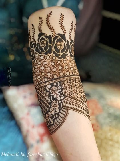 Another view of this bridal armband, showing the contrast between the dark florals and the fine lines.