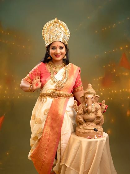 A festive and joyous portrait celebrating Ganesh Chaturthi. The mother-to-be offers a blessing, surrounded by festive lights and flags, embodying the spirit of celebration and new beginnings.