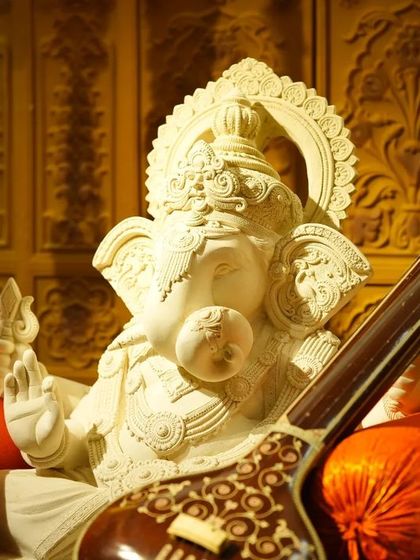 A hand-sculpted idol of Lord Ganesha on a swing, welcoming guests to the Graha Shanti Puja. This piece was created by a 17-year-old artist, as part of our commitment to supporting emerging talent.
