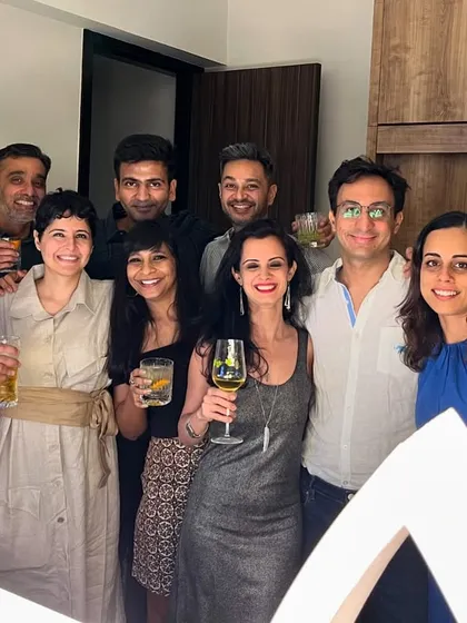 A group of happy guests enjoying their drinks at a house party. Our goal is to make sure everyone has a great time and a perfect drink in hand.