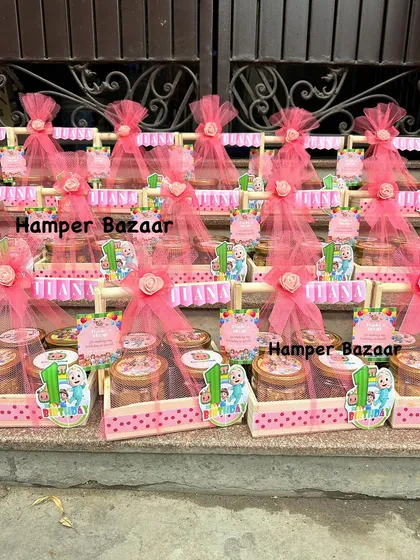 All lined up and ready to go! These pink Cocomelon hampers were a joy to create.