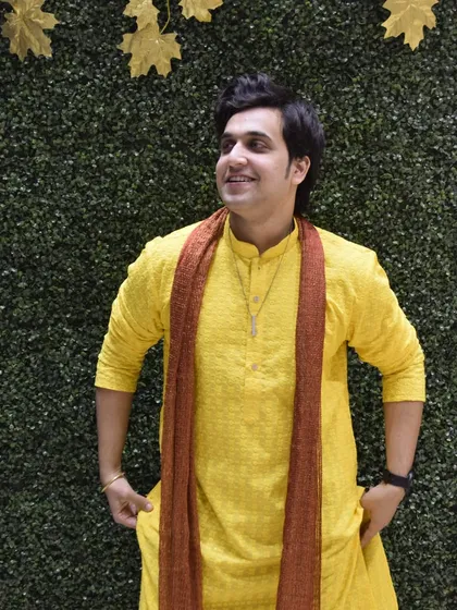 A bright and cheerful look in a yellow kurta with a contrasting scarf. This photo radiates positivity and is perfect for happy, celebratory occasions.