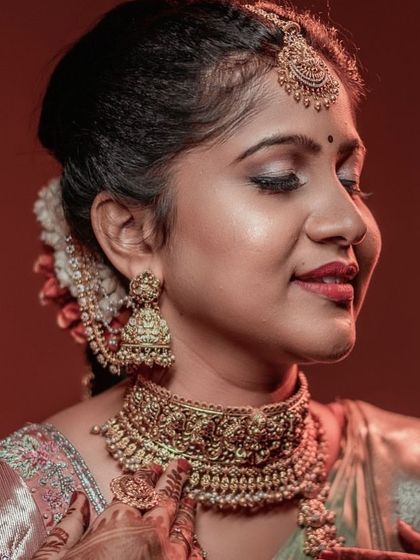A beautiful close-up of our bride. This shot highlights the intricate details of the antique-finish choker and the matching jhumkas.