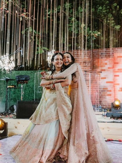 "I like me better when I’m with you." This beautiful, candid hug between the bride and her mother after their heartfelt mother-daughter performance says it all.