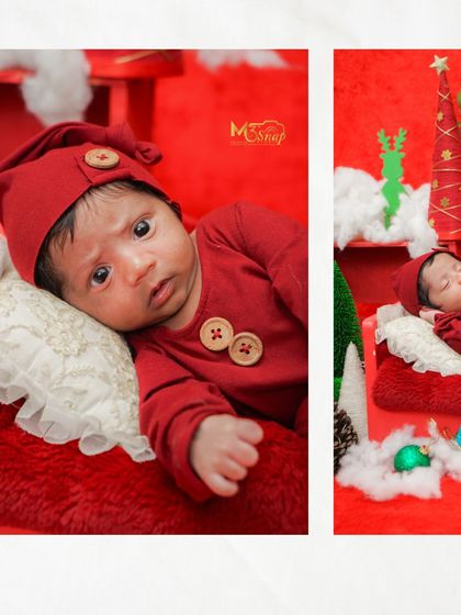 A close-up of the baby's sweet face. The red outfit and button details are so cute.