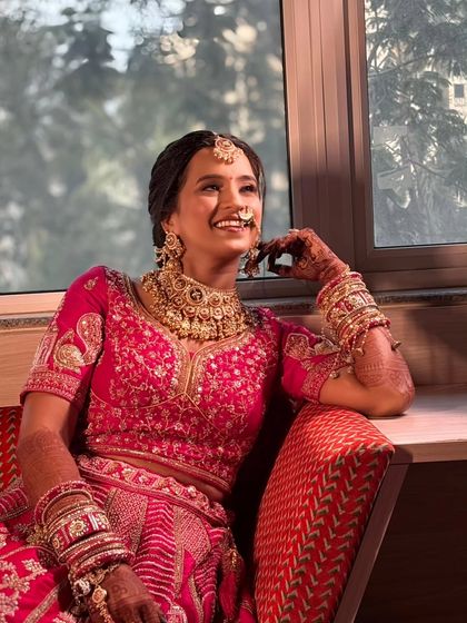 Another joyful shot by the window. The natural light beautifully illuminates her features and the soft, elegant makeup I created for her big day.