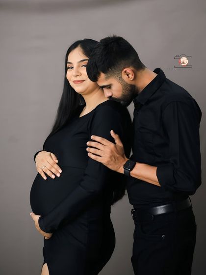A tender and intimate moment where the partner gently kisses his wife's shoulder. Her serene expression shows a sense of peace and love.