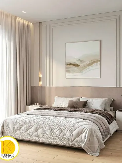 A serene and sophisticated bedroom with a neutral color palette. The wall features classic molding details, and the quilted bedspread adds a layer of texture and comfort.