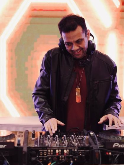 A happy moment behind the Pioneer decks. I'm experienced with various setups and can adapt to the equipment provided at any venue.