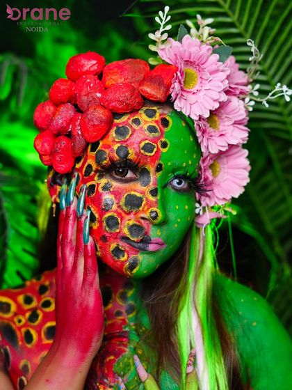 This pose highlights the hand and body paint, showing how the design flows from the face down to the body for a complete look.