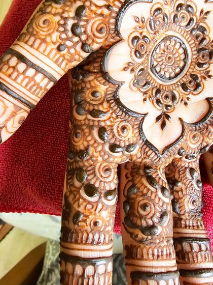 A close-up of a detailed mandala on the palm, a perfect example of intricate yet minimal design.