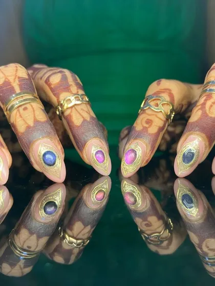 A close-up of the multi-colored gemstone nails, a perfect example of bespoke, high-end nail art.