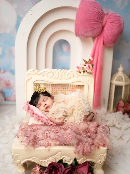Our sleeping beauty rests on an ornate chaise, dressed in lace and wearing a tiny crown. A truly royal portrait.
