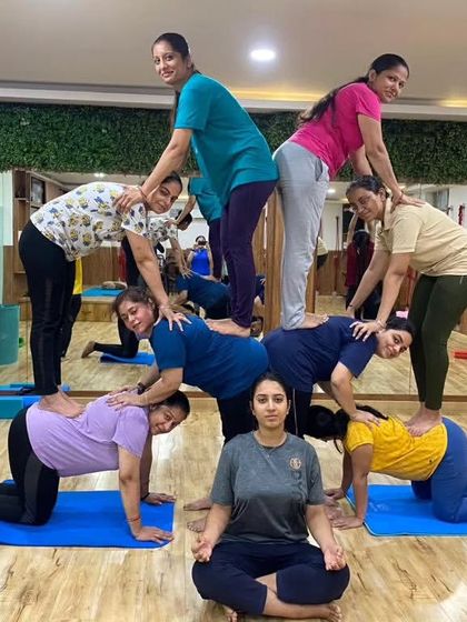 A large group of our female students creating an intricate and beautiful human pyramid. This showcases their incredible teamwork and collective strength.