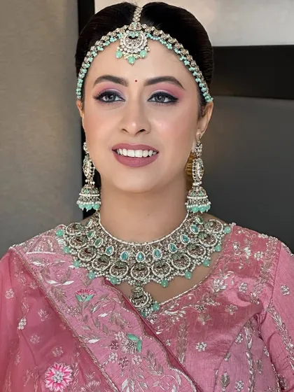 A close-up of my niece's phera look. The pink eyeshadow is blended beautifully to match her pastel jewelry and pink lehenga, creating a harmonious and modern bridal style.