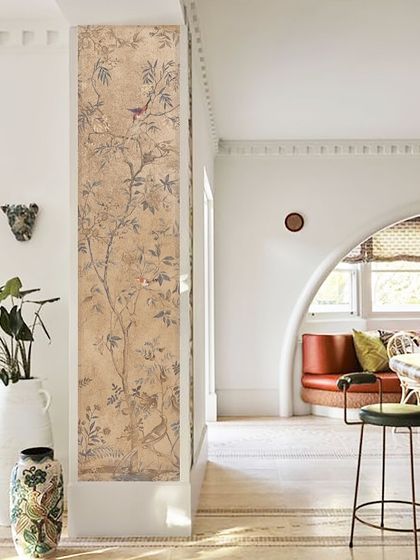 In this space, I used a heritage-inspired wallpaper as a narrow accent panel. It adds a touch of classic artistry and texture, beautifully contrasting with the clean white walls and modern architectural arch.