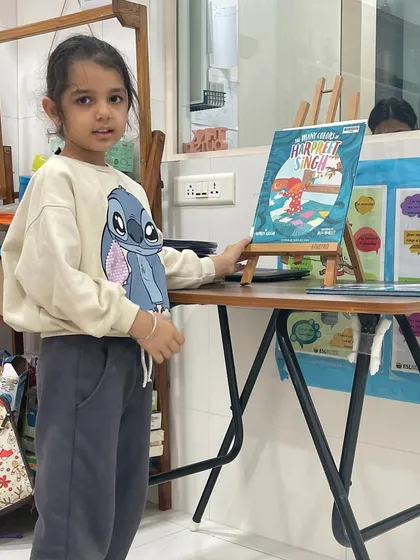In our "Share and Shine" session, a student presents her favorite book. This activity gives children a platform to talk about something they love, building their confidence in public speaking.