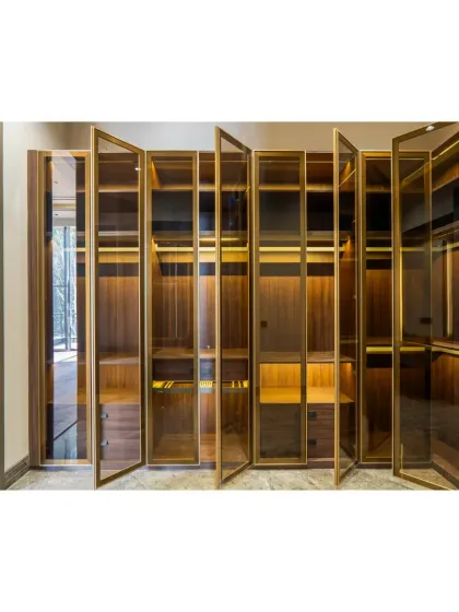 With the doors open, the closet's warm interior lighting is revealed. Every shelf and drawer is designed to feel like a little discovery, making the daily routine of getting dressed a special experience.