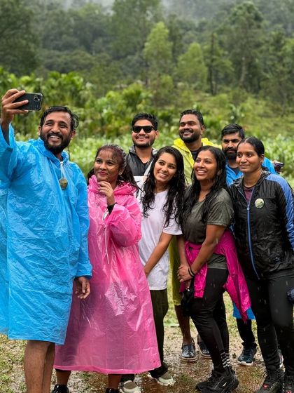 A selfie moment with friends in colorful raincoats during the Kodachadri trek.