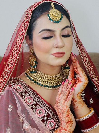 A close-up showing the bride's serene expression and the details of her makeup.