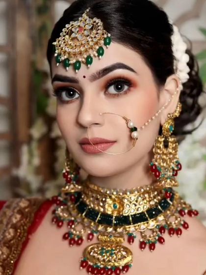 A classic red and green bridal set. The choker has a unique design with red and green stones, perfect for a traditional lehenga.