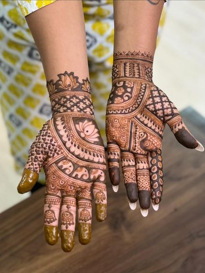 This design combines elephants, lotuses, and bells for a truly festive look. The mix of motifs is perfect for celebrating any special occasion.