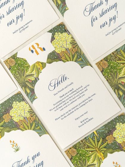 A set of welcome notes and thank-you cards for a wedding with a lush, botanical theme. The arched shape and rich green floral pattern create a warm and inviting welcome for guests.