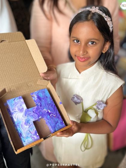 Another happy artist with her personalized initial. The purple and blue swirls make this 'H' a unique piece of decor for her room.