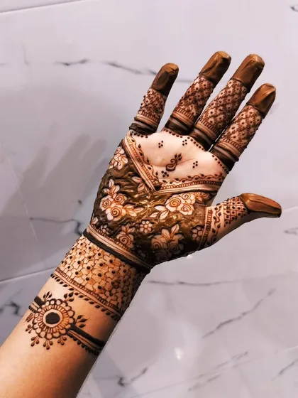 This design features a delicate floral pattern on the palm. The wristband has a unique design that looks like a bracelet.