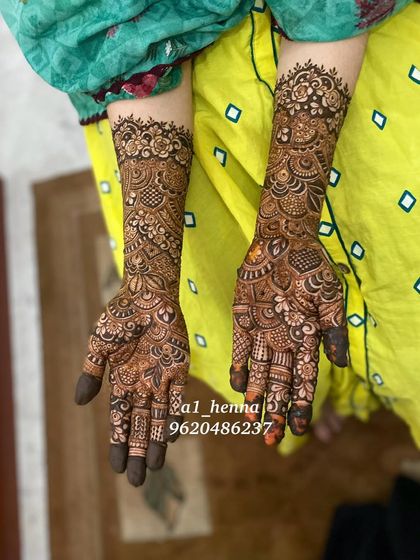 Full bridal henna with a focus on traditional Indian motifs, including paisleys, dots, and detailed finger work.