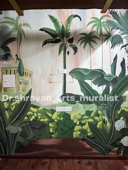 This tropical mural in a photo studio in Karaikal, Pondicherry, is designed to feel like a traditional South Indian village scene, complete with banana trees and a peacock.