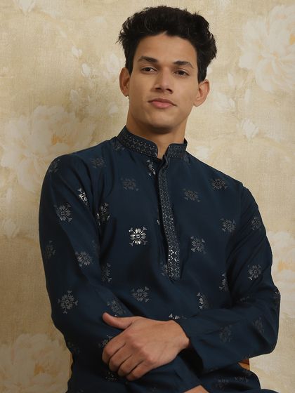 A close-up of a navy blue kurta with silver printed motifs. The detailing on the collar adds a touch of festive charm.
