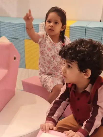 Young children exploring the soft play area, which is designed with safe, cushioned blocks and structures for our littlest visitors.
