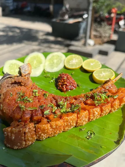 Our crispy pork ribs, seasoned with authentic Naga spices and served on a banana leaf. The skin is perfectly crackling while the meat remains tender and juicy. It’s a dish that’s both a feast for the eyes and a delight for anyone who loves rich, bold pork flavors.