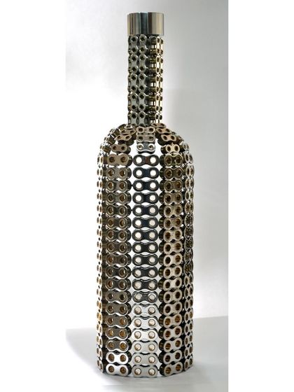 A studio shot of the bottle sculpture, highlighting its intricate, chain-link texture and classic form.