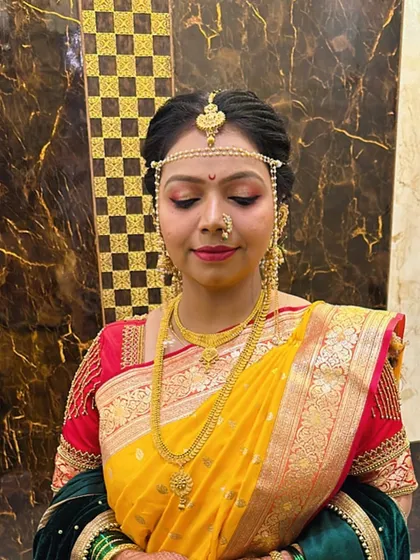 A close-up of my bride's makeup. The warm, shimmery eyeshadow complements her yellow saree and red blouse beautifully.