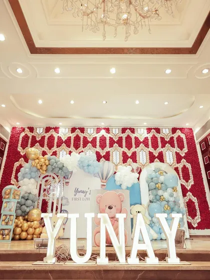 A beautiful teddy bear and hot air balloon theme for Yunay's First Lohri celebration. The setup against the venue's ornate red wall creates a stunning contrast.