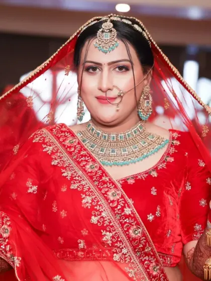 A classic bridal pose with the veil. Her detailed mehandi adds so much to her stunning look.