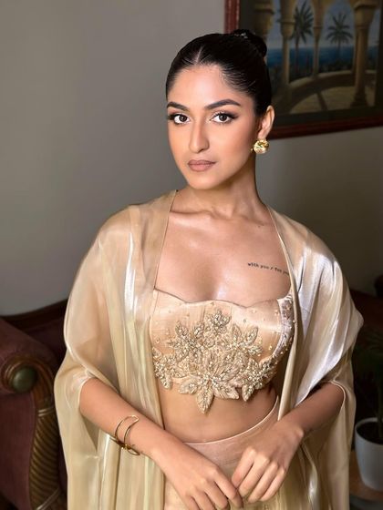 A full view of the Latina-inspired glam. The look is powerful and confident, with a focus on sculpted features and a sultry gaze.