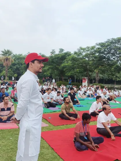 I have experience leading large scale wellness events for corporations and communities. Here, I am guiding a large group through a morning yoga session, creating a shared sense of peace and energy that participants carry with them throughout their day.