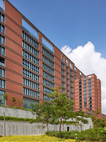 The staggering of the towers and the extensive use of native trees at the Wipro Hyderabad campus are deliberate climate-conscious design choices. This approach maximizes shade and harnesses wind flow, creating a workspace that breathes with its environment and reduces reliance on artificial cooling.
